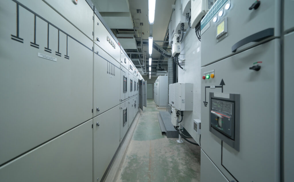 Interior of electrical room. Power energy motor machinery cabinets in control or server room, main operator station network and circuit center in industry factory manufacturing system. generator